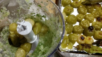Blending the onion, coriander, lime juice and tomatillos